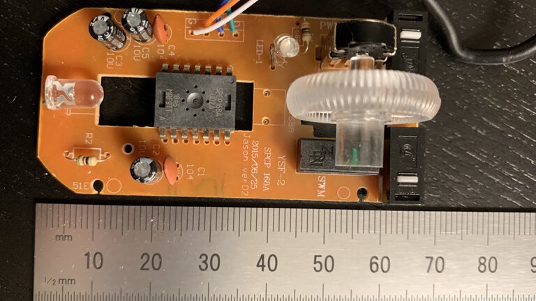 The mouse PCB with a ruler showing the 7cm length